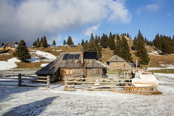 Velika planina mountain 1666 m in Kamnik Savinja Alps in Slovenia, winter hiking in herdsmen’s...