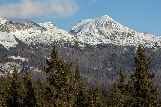 Velika planina mountain 1666 m in Kamnik Savinja Alps in Slovenia, winter hiking in herdsmen&rsquo;s huts village covered with snow, with white mountain peaks
