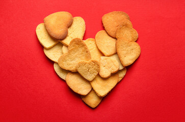 Heart made of tasty cookies on red background. Valentines Day celebration