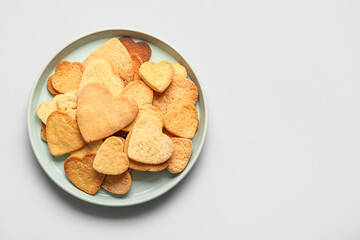 Plate with sweet heart shaped cookies on light background. Valentines Day celebration
