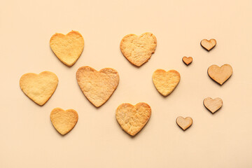 Sweet heart shaped cookies and wooden decor on color background. Valentines Day celebration