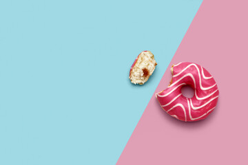 Bitten donut on pink and blue background
