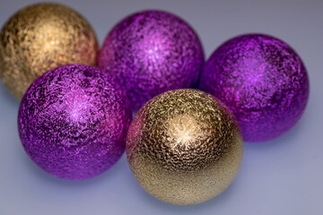 Christmas gold and purple Christmas balls for a Christmas tree close-up