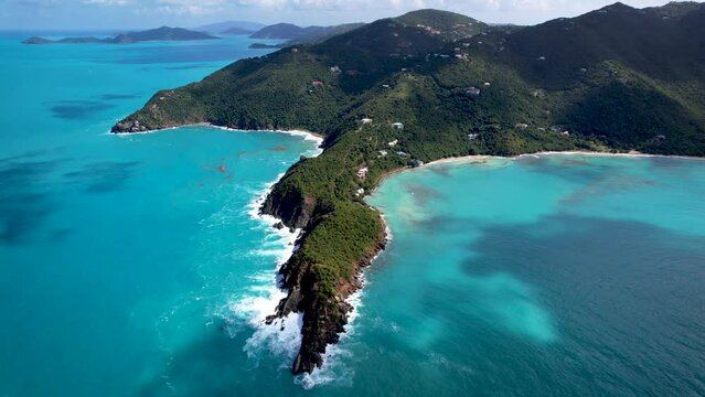 Aerial footage of waves crashing over beach and coastline on Tortola, British Virgin Islands
