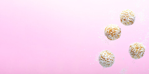 Levitating Coconut Vegan Sweets, Delicious Candy Balls, Healthy Candies on Pink Background
