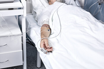ill senior male patient in hospital bed. Healthcare and treatments concept. mature man recovering...