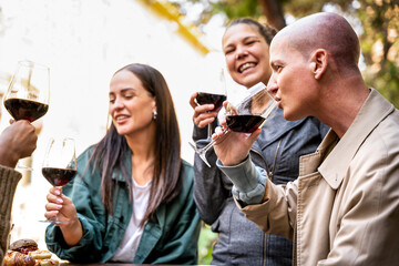 People enjoying at winery bar dehor - Girls and guys having fun together at open air cafe - Friendship lifestyle concept - Focus on right guy
