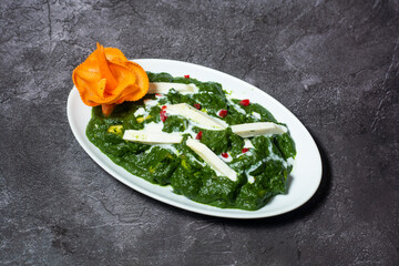 Palak paneer spinach cheese served in dish isolated on grey background top view of indian and bangladesh food