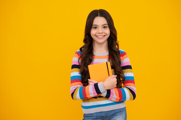 Back to school. Teenager schoolgirl with book ready to learn. School girl children on isolated yellow studio background. Happy teenager, positive and smiling emotions of teen girl.