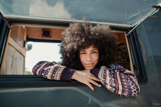 Girl Leaning Out Of The Window Of Her Camper Van