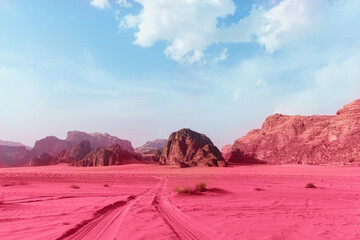 Blue sky and pink-toned sand.