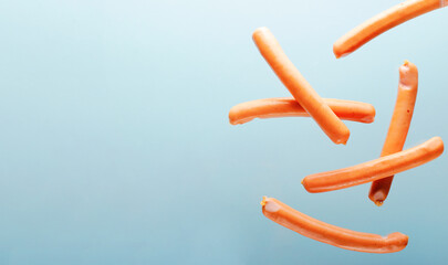 Sausages Levitating, Flying Food Concept on Light Blue background
