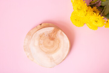 Wooden podium or pedestal with chrysanthemum flowers top view. Mockup for your cosmetic products