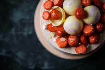biscuit cake decorated with strawberries and chocolate balls