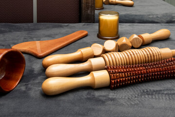 Wooden devices to apply wood therapy massages with rollers and candles
