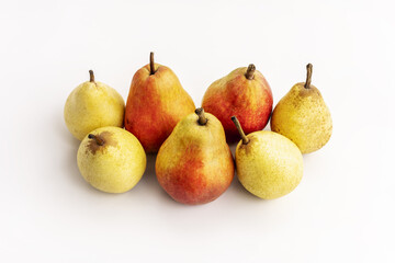 A few ripe seasonal pears of various species on a white background