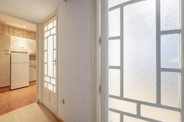 Interior corridor of a house with solid wood edged doors with translucent glass