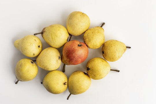 A bunch of ripe pears with a redder one in the center