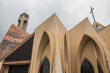 Exterior with arches, crosses, decorative walls of Catholics church in Abuja, church is known as The National Christian Centre (previously known as the National Ecumenical Centre, Nigeria, Abuja  - obrazy, fototapety, plakaty