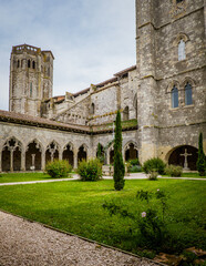Fototapeta premium The medieval cloister and tower of the Saint Pierre collegial church in La Romieu, south of France (Gers)