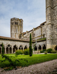 The medieval cloister and tower of the Saint Pierre collegial church in La Romieu, south of France (Gers)