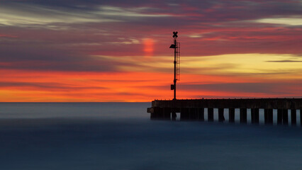 Obraz na płótnie Canvas sunset at the pier in long exposure