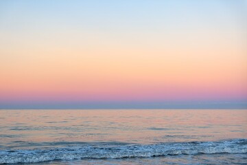 Fototapeta na wymiar Beautiful sunny and pink sunrise on the beach