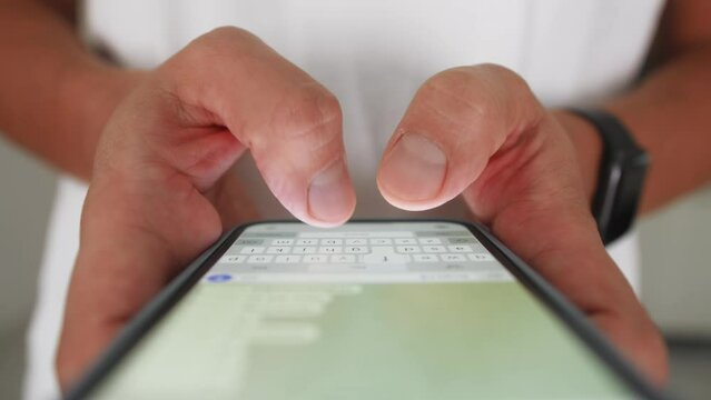 Woman chatting online on smartphone macro close up, typing text message, touching touchscreen keyboard, using messenger application. Female holding mobile phone, close up, swiping social media. 
