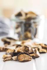 Sliced dried mushrooms on white table.