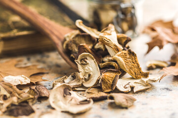 Sliced dried mushrooms in wooden spoon.