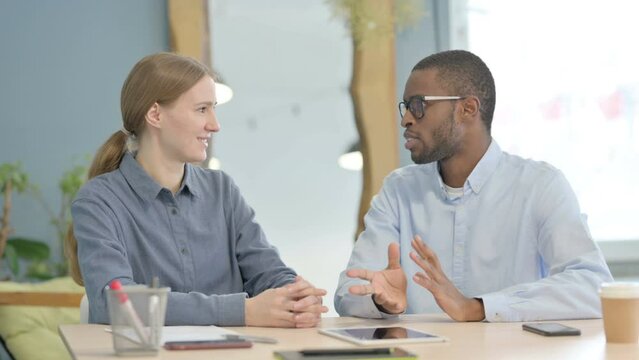 Young Business People Discussing Work in Office