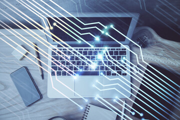 Double exposure of desktop computer and technology theme hologram. Concept of software development.