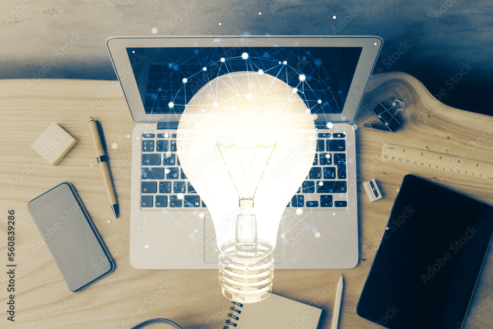 Poster computer on desktop in office with bulb icon hologram. multi exposure. concept of idea.