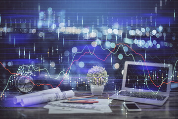 Financial graph colorful drawing and table with computer on background. Double exposure. Concept of international markets.