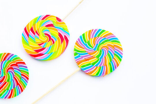 Rainbow lollipop on white background.