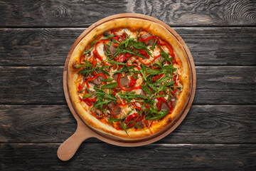 Pizza with meat, red pepper, cheese, arugula