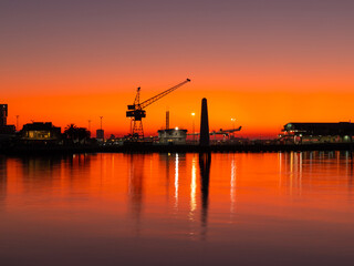 Silhouette of crane at Port Melbourne during sunrise time.