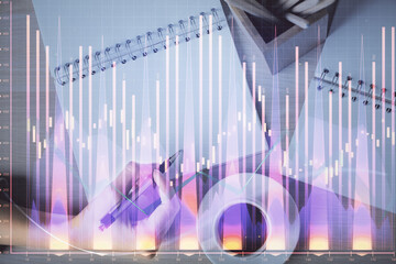 Multi exposure of woman's hands making notes with forex graph hologram. Concept of technical analysis.