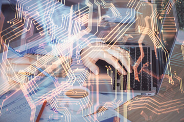 Technology theme hologram with man working on computer on background. High tech concept. Multi exposure.