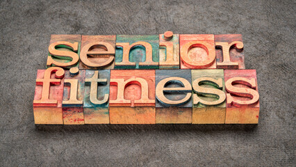 Fototapeta premium senior fitness word abstract in letterpress wood type against textured bark paper, aging and exercise concept