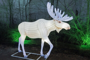 Big Illuminated sculpture of a Deer. The Christmas advertising campaign. A piece of the Arctic in the city, luminous animals of different species. The nighttime of the New Year.