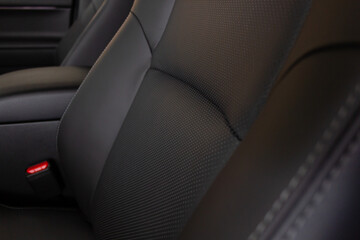 Luxury car inside. Interior of a prestigious modern car. Comfortable leather seats. Cockpit in black perforated leather.