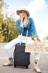 Grimacing, waiting, independent blond woman in cowgirl hat hitchhike by road with plate anywhere...