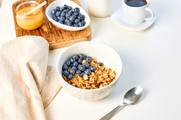 Fresh fragrant homemade granola made from oatmeal, honey, nuts and fresh blueberries. Balanced breakfast or snack.