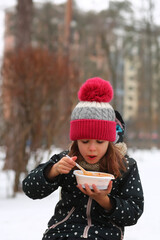 Girl eating free borscht in the Irpin park from the Point of Invincibility and volunteers because...