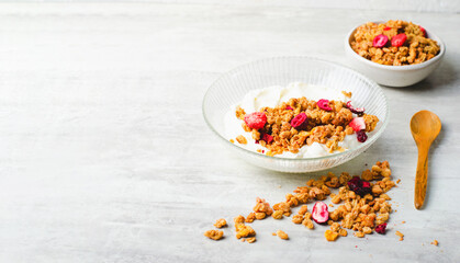 Granola with Yogurt in a Boal, Healthy Breakfast, Muesli with Dried Berries on Bright Concrete Background