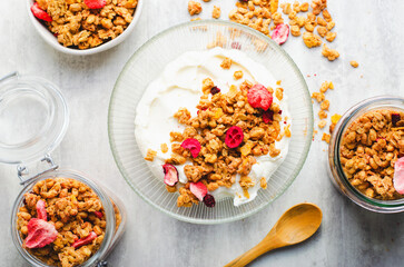 Granola with Yogurt in a Boal, Healthy Breakfast, Muesli with Dried Berries on Bright Concrete Background