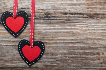 two hearts on a textured wooden background. Valentine's day background. Space for text.