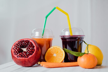 Fresh juices. Assortment of colored fruit juices to take away in a plastic glass