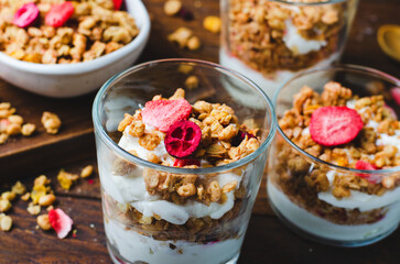 Granola and Yogurt Parfaits, Healthy Breakfast or Snack, Muesli with Dried Berries on Wooden Background